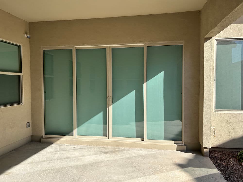Sliding glass doors leading to a bright outdoor patio space in a modern home.